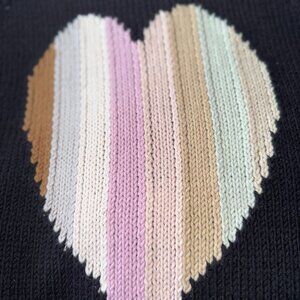 LISA TODD NEVER WORN SWEATER WITH PASEL HEART ON BACK